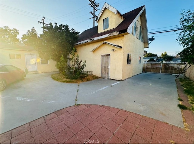 back of property featuring a patio area, fence, and stucco siding