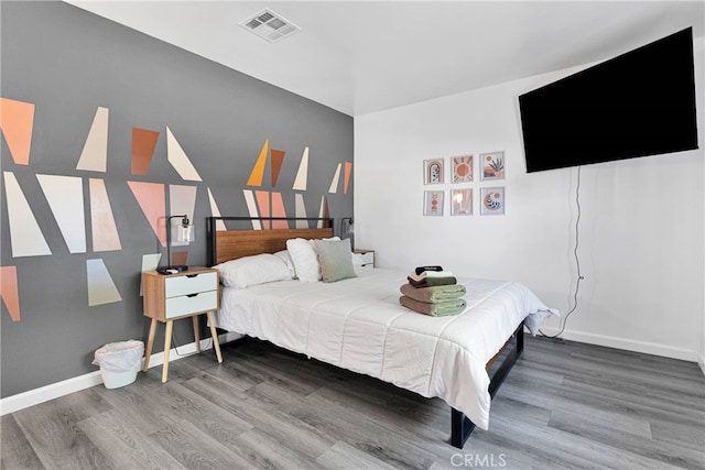 bedroom with wood-type flooring