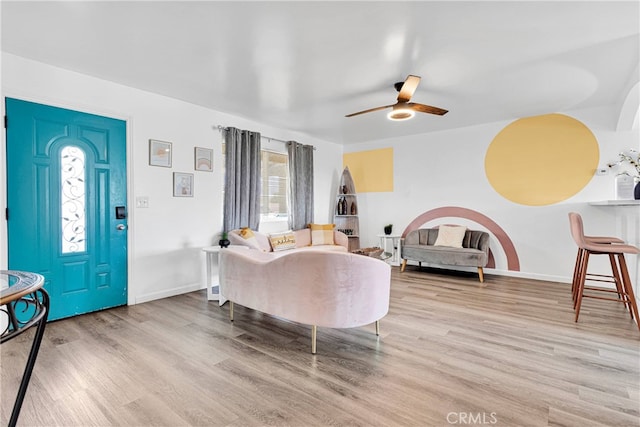 living room with light hardwood / wood-style floors and ceiling fan