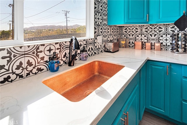 kitchen with a wealth of natural light, sink, and backsplash