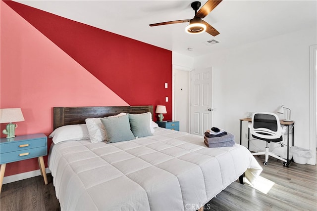 bedroom with wood-type flooring and ceiling fan