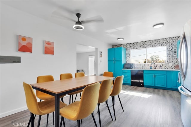 dining space featuring sink, ceiling fan, and light hardwood / wood-style flooring