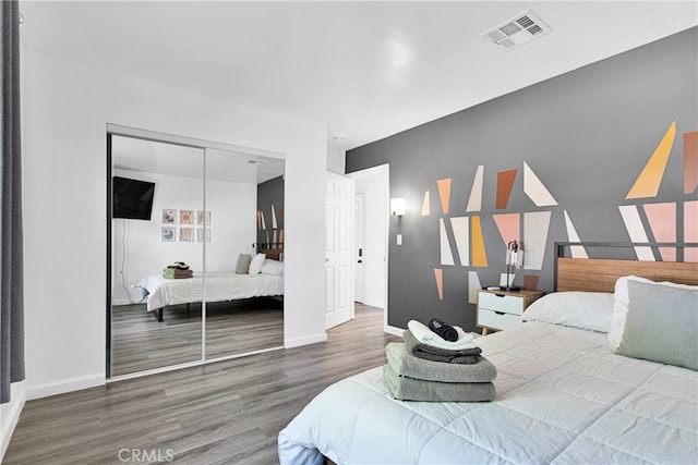 bedroom with a closet and wood-type flooring