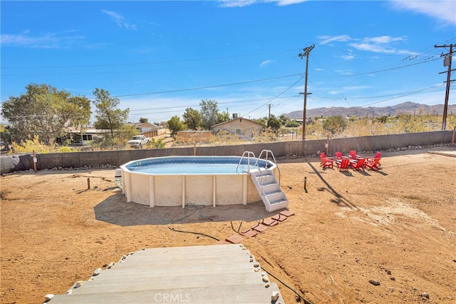 view of swimming pool with a mountain view