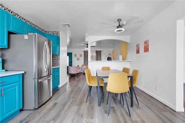 dining room with ceiling fan and light wood-type flooring