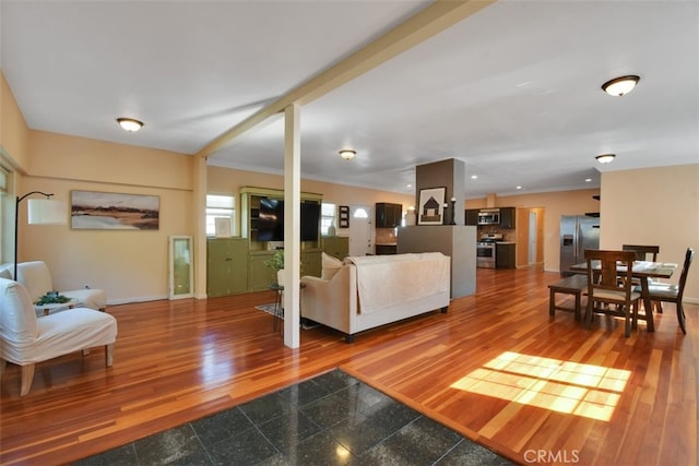 living room with crown molding and hardwood / wood-style floors