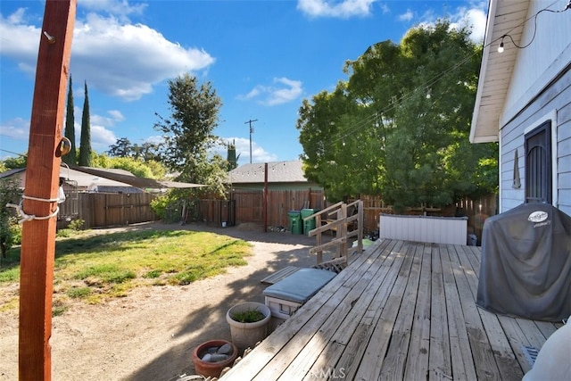 wooden deck featuring a lawn