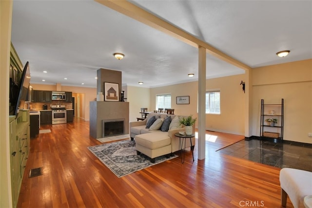 living room featuring crown molding and dark hardwood / wood-style flooring