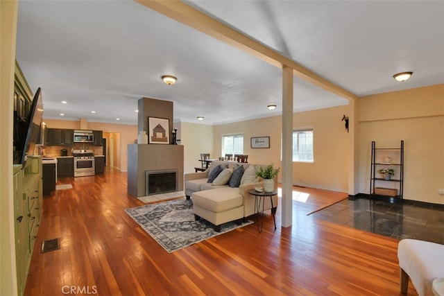 191 Hazel St, Gridley, CA 95948 - living room featuring dark wood-style flooring, crown molding, and baseboards