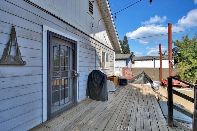 wooden terrace with a grill