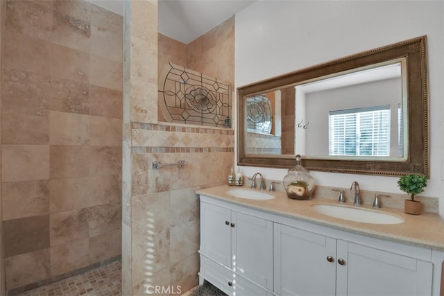 bathroom featuring tile walls, vanity, and a shower