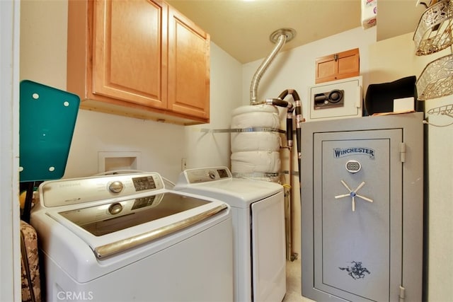 laundry area featuring cabinets and washing machine and clothes dryer