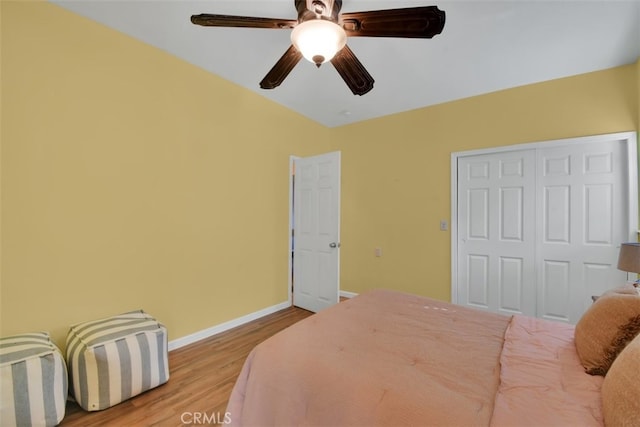 bedroom with light hardwood / wood-style floors, a closet, and ceiling fan