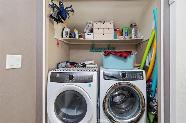 clothes washing area featuring laundry area and washer and dryer