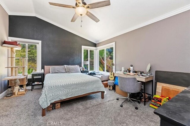 carpeted bedroom featuring crown molding, vaulted ceiling, and ceiling fan