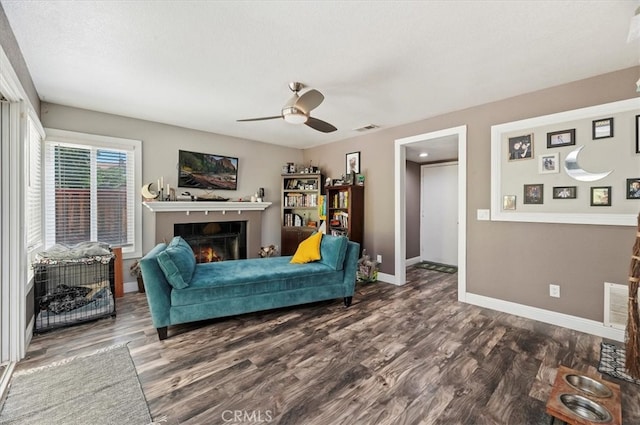 living room featuring a textured ceiling, dark hardwood / wood-style floors, and ceiling fan