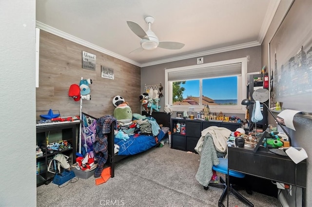 bedroom with carpet floors, ornamental molding, wood walls, and a ceiling fan