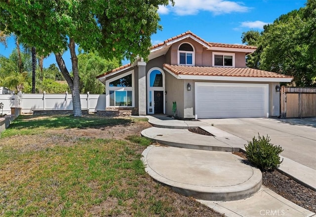 mediterranean / spanish-style home with a front yard and a garage