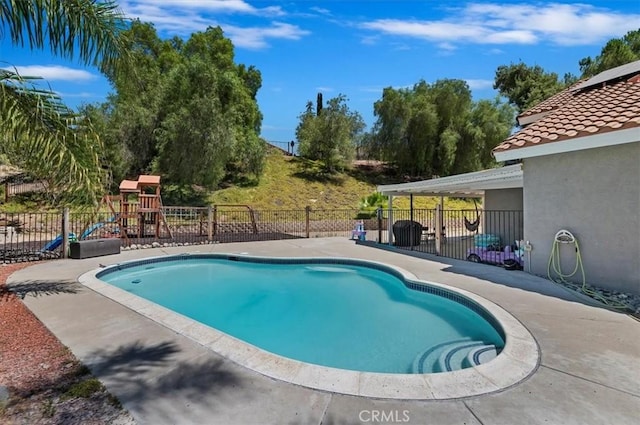 view of swimming pool featuring a fenced in pool, a playground, fence, and a patio