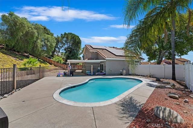 view of swimming pool with a fenced in pool, a fenced backyard, and a patio