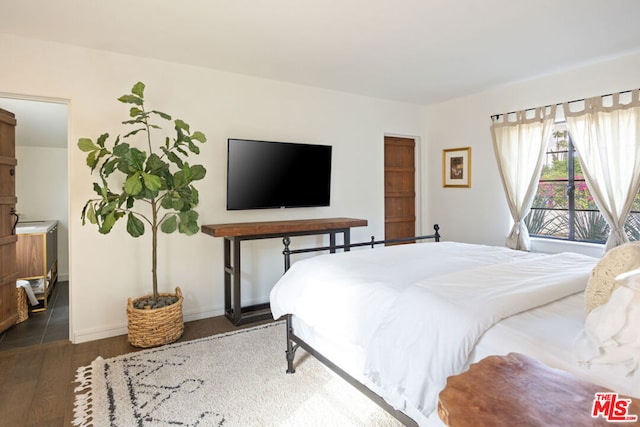 bedroom with dark hardwood / wood-style flooring