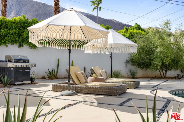 view of patio with grilling area and a mountain view