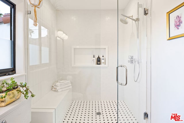 bathroom featuring a shower with shower door