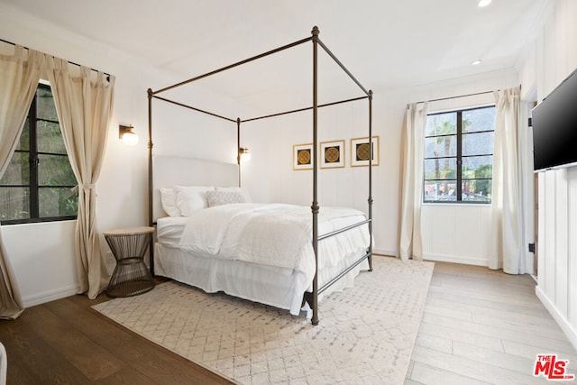 bedroom featuring hardwood / wood-style flooring and crown molding