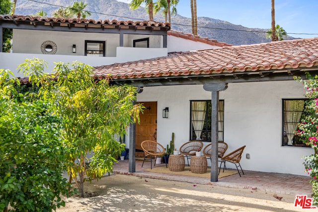 entrance to property with a patio and a mountain view