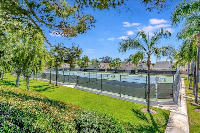 view of sport court with a lawn