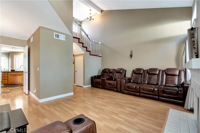 interior space featuring light hardwood / wood-style floors, high vaulted ceiling, and plenty of natural light