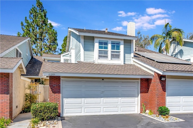 view of front of house with solar panels and a garage