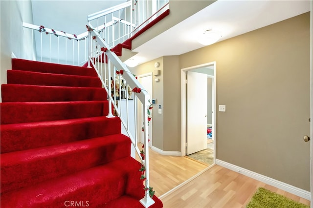 stairs with hardwood / wood-style floors