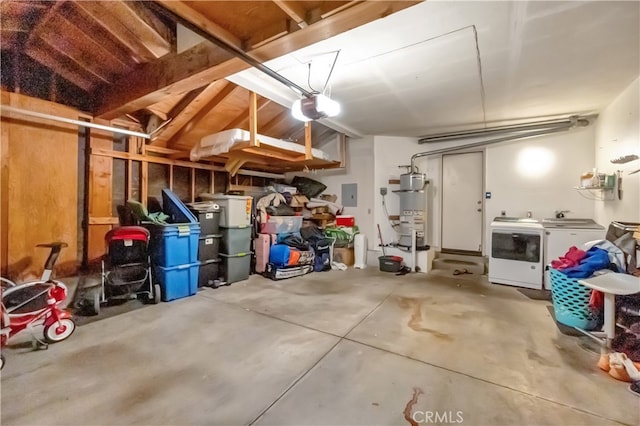 garage featuring washer and dryer, secured water heater, and a garage door opener