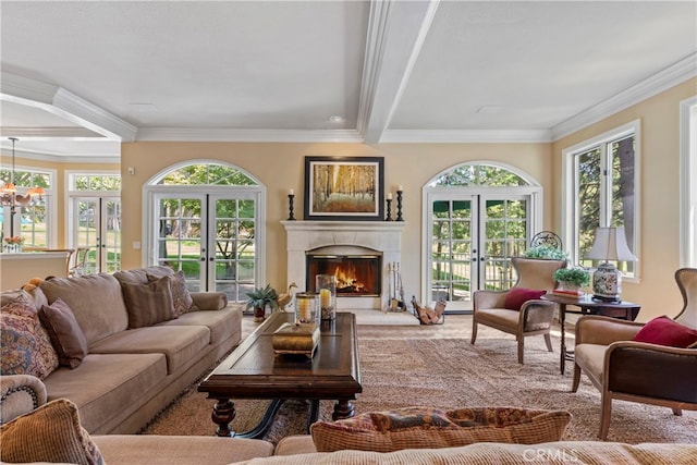 living room featuring ornamental molding, beamed ceiling, and french doors