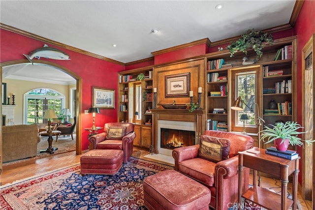 sitting room with hardwood / wood-style flooring and crown molding