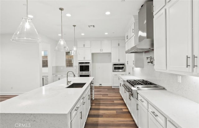 21239 W Wildflower Way, Chatsworth, CA 91311 - kitchen with wall chimney range hood, appliances with stainless steel finishes, dark wood-style flooring, white cabinetry, and recessed lighting