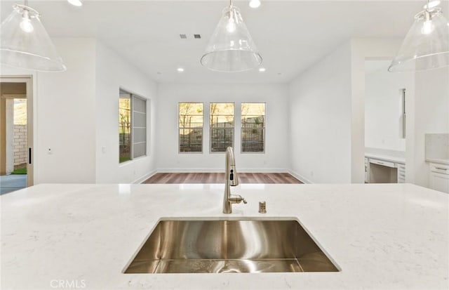 21239 W Wildflower Way, Chatsworth, CA 91311 - kitchen featuring recessed lighting, light stone countertops, hanging light fixtures, wood finished floors, and open floor plan