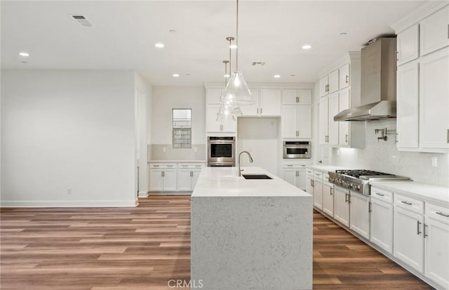 21239 W Wildflower Way, Chatsworth, CA 91311 - kitchen with appliances with stainless steel finishes, wall chimney range hood, light wood-style floors, tasteful backsplash, and recessed lighting