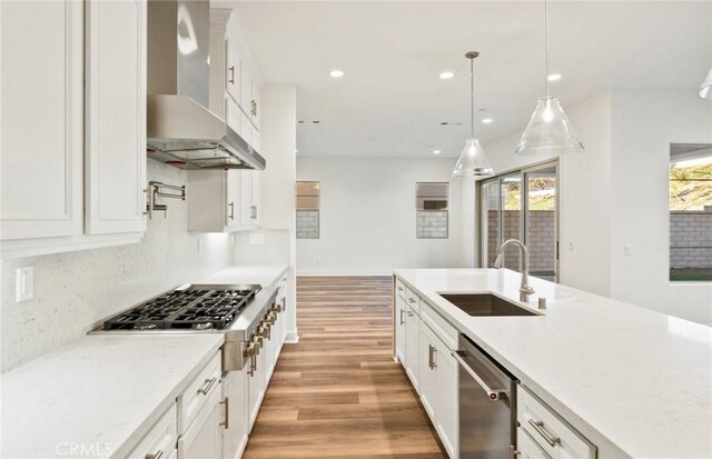 21239 W Wildflower Way, Chatsworth, CA 91311 - kitchen with wall chimney exhaust hood, stainless steel appliances, light wood finished floors, white cabinetry, and recessed lighting