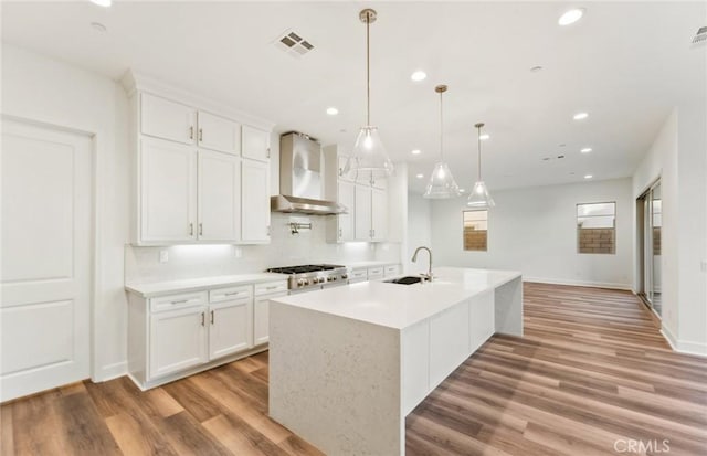 21239 W Wildflower Way, Chatsworth, CA 91311 - kitchen featuring wall chimney exhaust hood, light wood-type flooring, white cabinetry, stainless steel gas stovetop, and recessed lighting