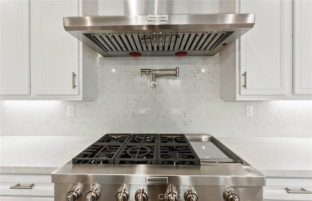21239 W Wildflower Way, Chatsworth, CA 91311 - kitchen with extractor fan, white cabinetry, backsplash, light stone countertops, and stove