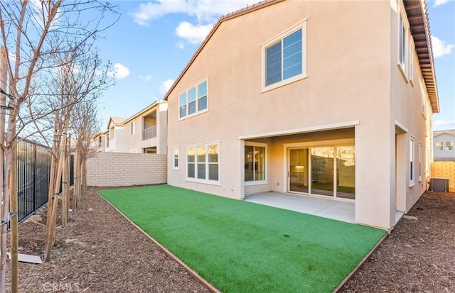 21239 W Wildflower Way, Chatsworth, CA 91311 - back of property with stucco siding, a fenced backyard, and a patio area