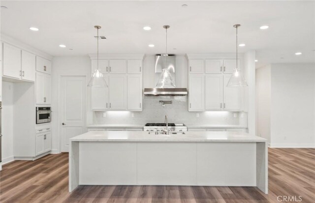 21239 W Wildflower Way, Chatsworth, CA 91311 - kitchen with light countertops, wood finished floors, a kitchen island with sink, white cabinetry, and recessed lighting