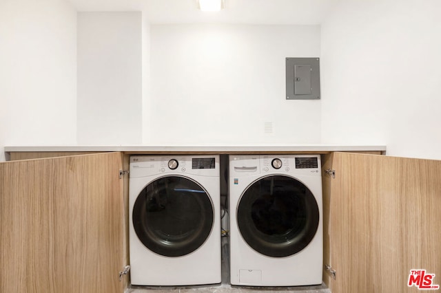 clothes washing area featuring electric panel and washer and dryer