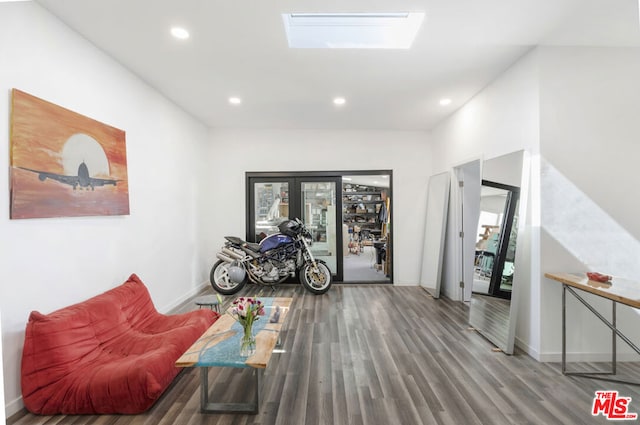 sitting room featuring french doors, a skylight, and wood-type flooring