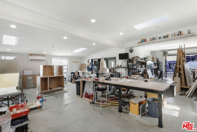 garage with a workshop area and an AC wall unit