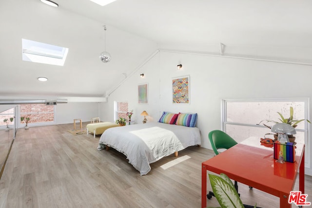 bedroom with light hardwood / wood-style flooring, multiple windows, and lofted ceiling with skylight