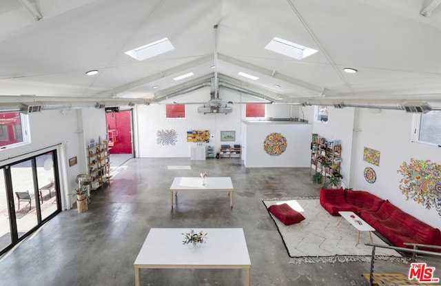 living room featuring lofted ceiling with skylight