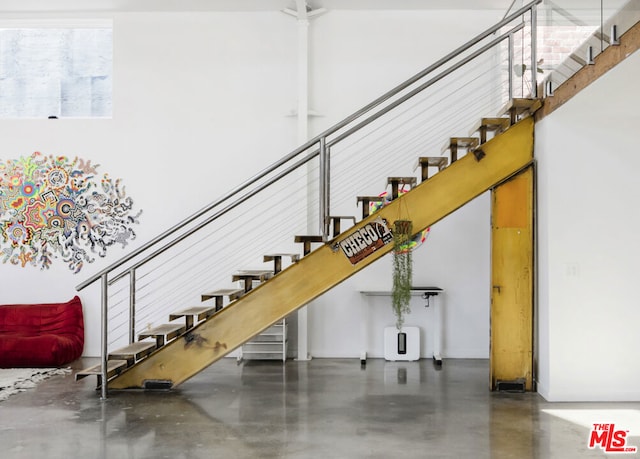 stairway featuring concrete floors